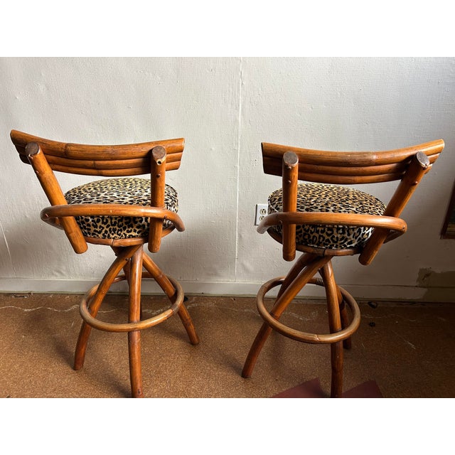 Authentic 1950's Mid-Century bent rattan bar stools with leopard cushions. In very good condition for their era- some wear...