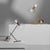 With a clear suggestive illumination, the Zosia table lamp elevates twin points of light upon thin rods, suspended within...