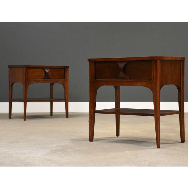 A pair of mid century modern walnut and rosewood nightstands with curved details made by Kent Coffey Perspecta....