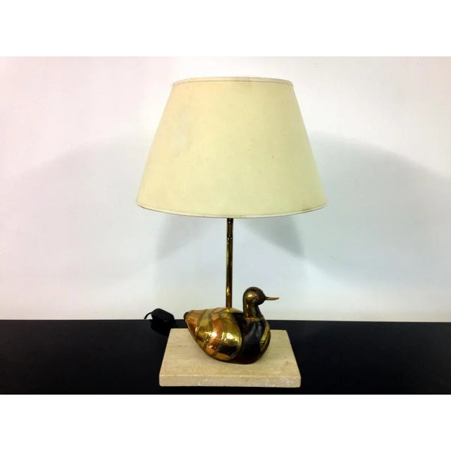 This duck lamp is made from brass, copper and wood with a travertine base. It was probably manufactured in Belgium and can...