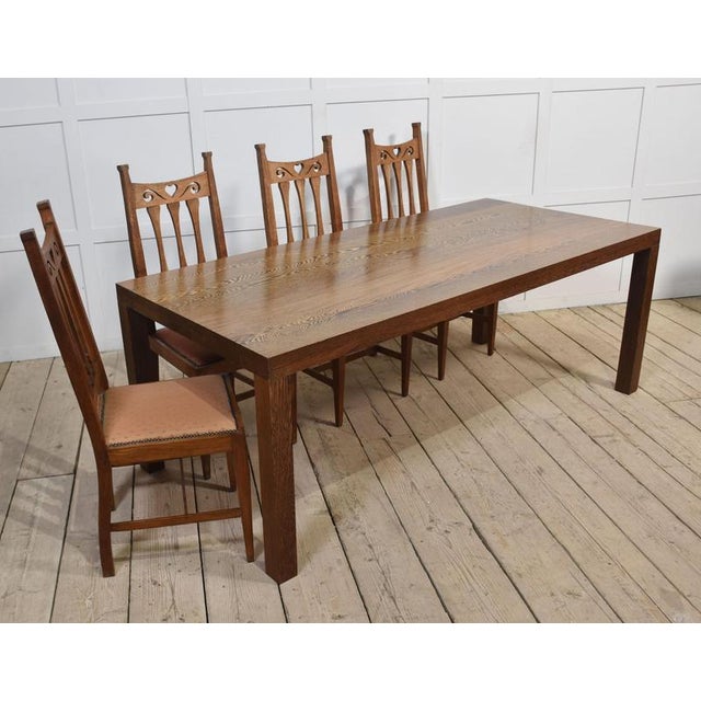 Oak dining table, the large rectangular well figured solid oak top raised on four square supports. The table will...