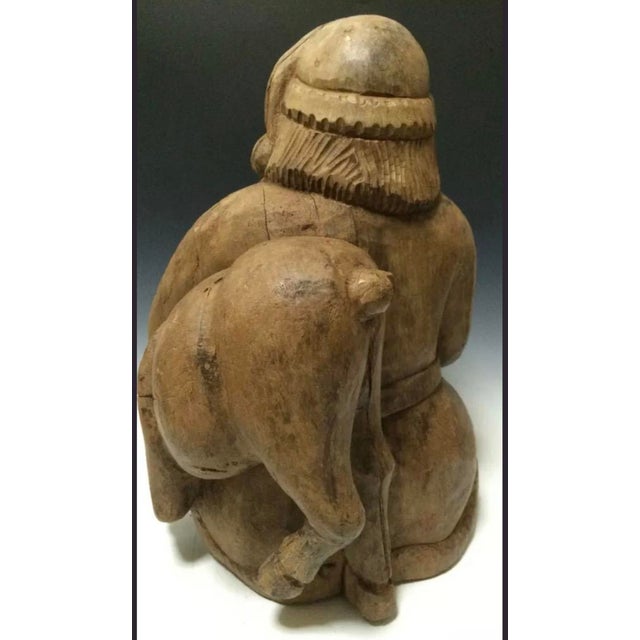 ITEM NAME: Vintage Hand Carved Wooden Santa Claus Holding Deer Sculpture ORIGIN: Philippines AGES: Late 20th Century...