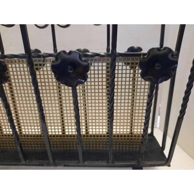 Unusual and very heavy solid wroth iron magazine rack/holder. Flower accents on both sides. Two sections to hold magazines...