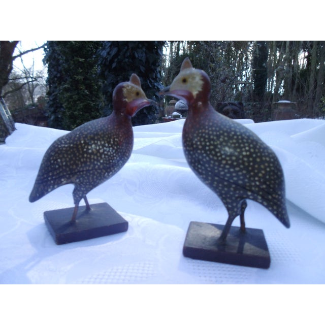 2 small antique wooden guinea fowls, featuring original, authentic paintwork and patina. Signs of wear are present.