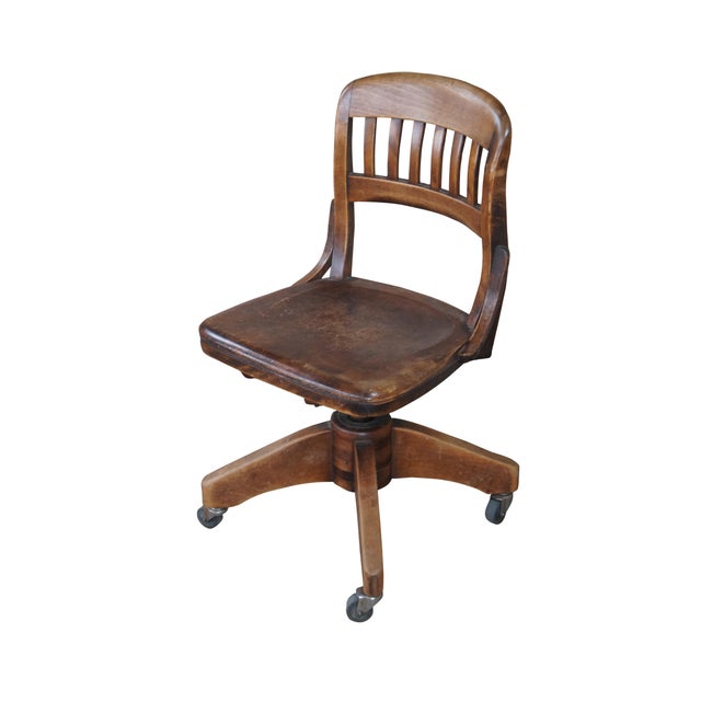 Antique Victorian walnut desk chair featuring a slatted back with rotating seat and swivel castors. These chairs date back...