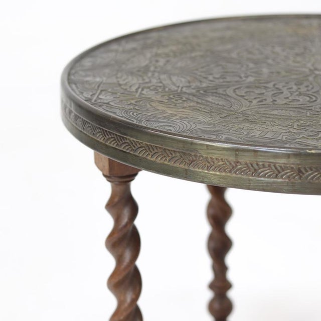 Charming antique side table from the 1920s with a beautiful twisted oak frame and an attractive brass top. The piece is in...