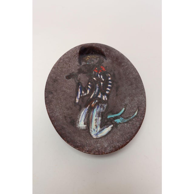 Decorative plate/plaque depicting a fiddler by Vallauris artist, Marius Musarra for his studio, Mabyjo's (ca. 1960s,...