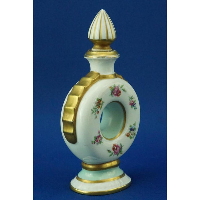 Item description: Small perfume bottle, made of fine glazed hard-paste porcelain, entirely hand-decorated with floral...