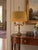 Elegant vintage two-light candelabra table lamp in the Louis XVI and French Neoclassical style with its vintage oval...