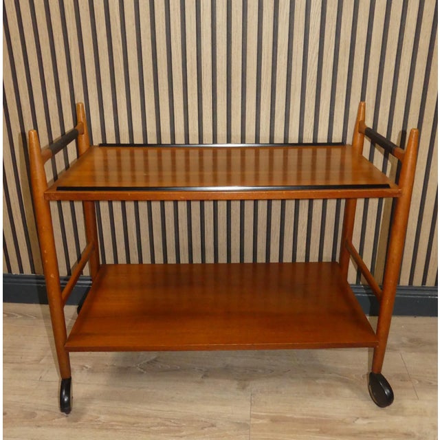 Mid-Century Bar or tea cart in a sensationally beautiful design - straight shape with chic black details! This design...