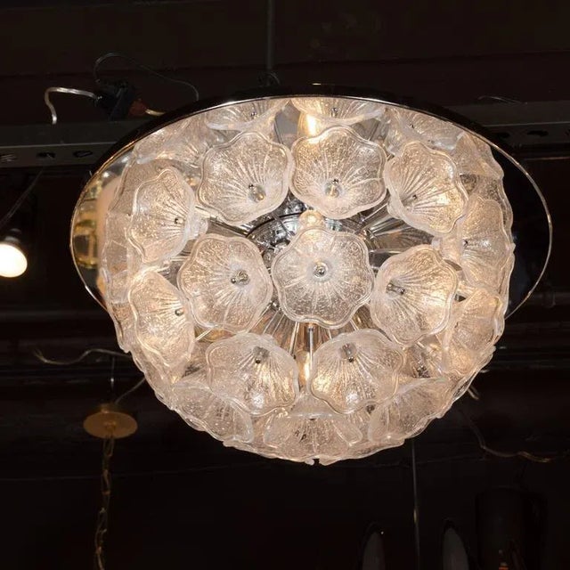 This luminous flush mount Sputnik chandelier features an explosion of handblown Murano glass flower petals connected to a...