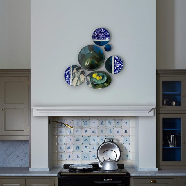 "Still Life with Golden Apples" consists of 6 plates combined with a still life of a platter with two golden apples and a...