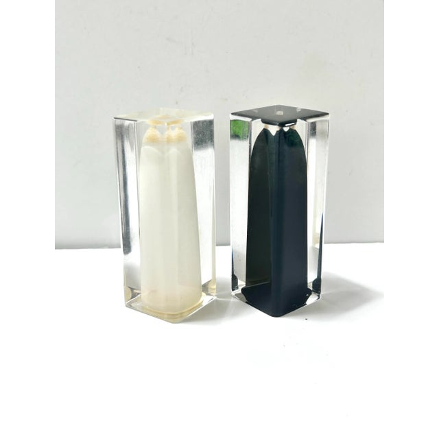 A striking pair of 1970s salt and pepper shakers by iconic Italian design house Fratelli Guzzini. Crafted from clear...