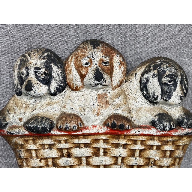 Unique vintage 1930's hard rubber puppies in a wicker basket doorstop. Molded out of black rubber, with a hand painted...