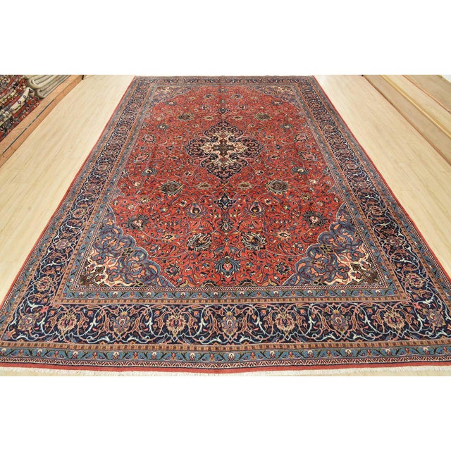 An authentic vintage traditional Sarouk rug hand-knotted with fine wool and natural dyes. This oriental rug features a...