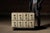 Low-profile industrial storage cabinet featuring eight small-format drawers arranged in two horizontal rows, reminiscent...