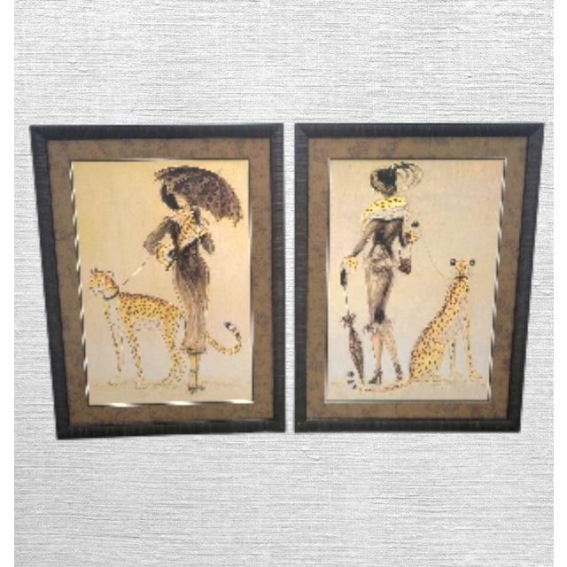 A pair of framed Cosmopolitan black framed elegant fashion ladies wall prints By Karen Dupree. The prints have such a fun...