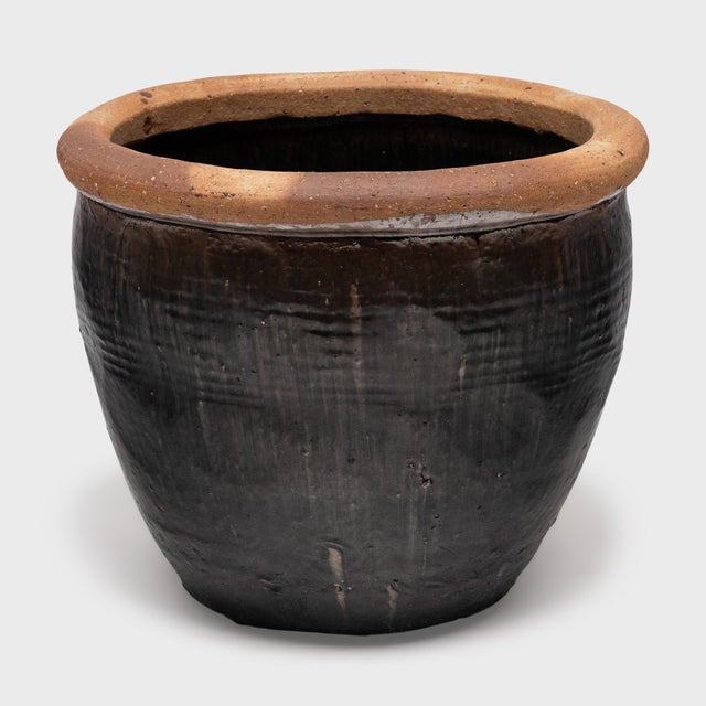This 19th-century Chinese rain pot was sculpted by hand with impressive scale and wabi-sabi texture. Ceramic vessels of...