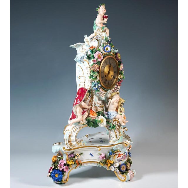 The clock was designed by Leuteritz using old moulds in the Rococo style: The case rises up on three sturdy rocaille feet...