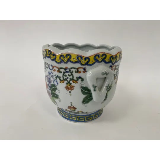 Round porcelain tobacco leaf planter with handles and a scalloped edge. Does not have a drainage hole.