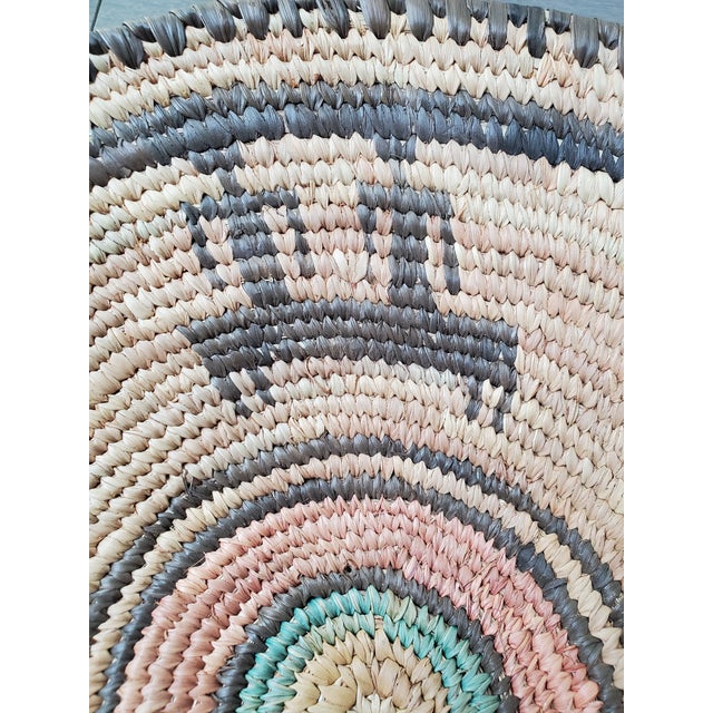 Lovely handwoven vintage grass basket with indigenous motif. Unsure of origin but due to the material and dye colors is it...