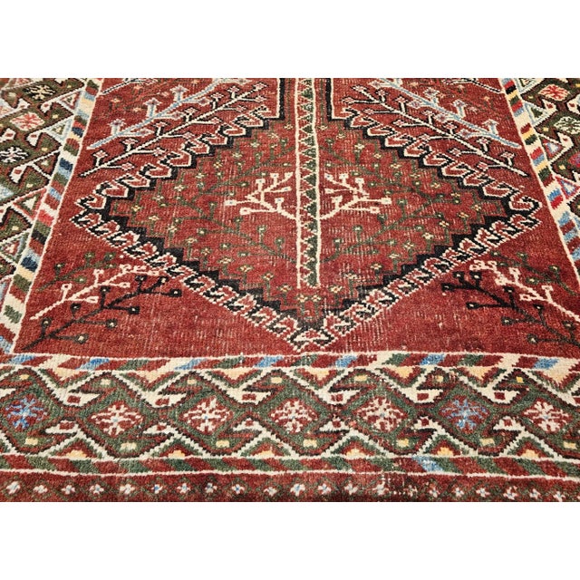 This vintage Persian Shiraz tribal area rug is a striking example of Southwestern Persia’s weaving heritage, featuring a...