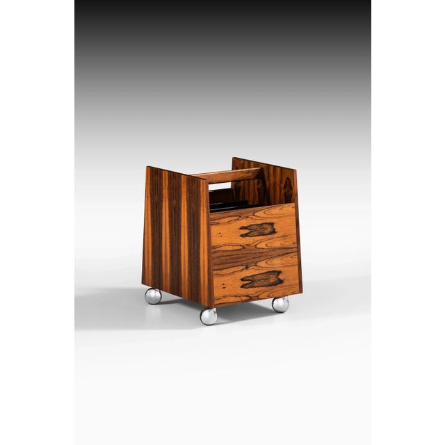Magazine rack in rosewood designed by Rolf Hesland. Produced by Bruksbo / Bagn Furniture Industry in Norway. This piece is...