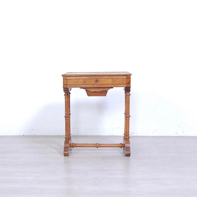 Work table made of walnut and walnut wood. It has shaped feet united by turned cross, two legs turned on each side, upper...