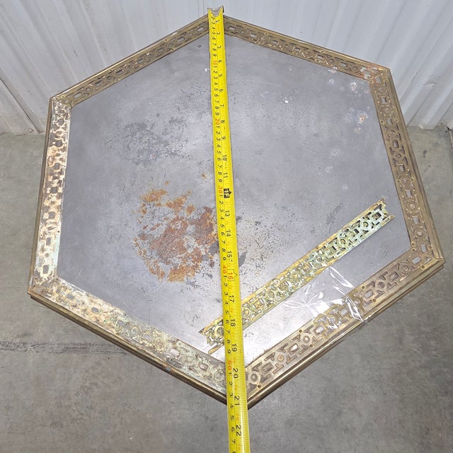 This is a small, elegant pedestal table with a white ceramic base. The base is a fluted column with a carved floral foot....