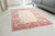 This is a vintage Turkish Oushak rug from the Mid 20th Century. The piece was hand-knotted.