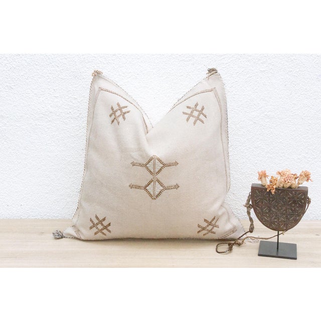 Indulge in the grounded beauty of our handcrafted Moroccan cactus silk pillow, measuring approximately 22 inches square....