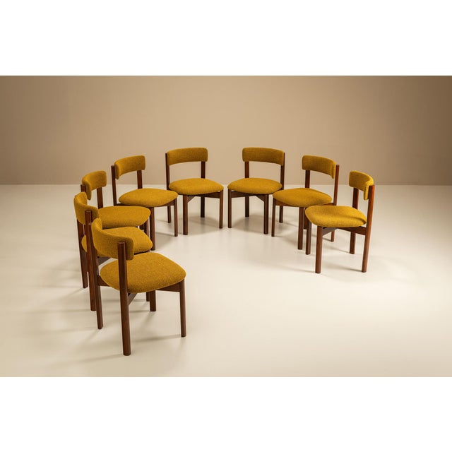 This set of eight dining chairs was crafted in Italy during the 1970s. Balancing geometry with warmth, each chair features...