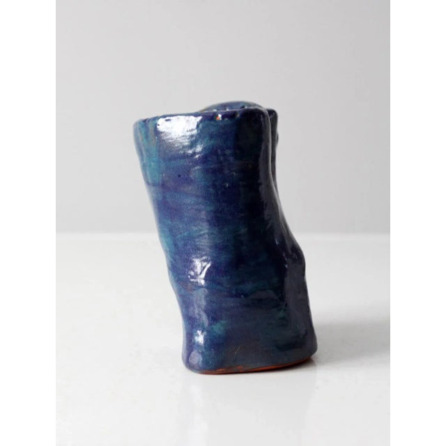 This vintage studio pottery mug features a blocky, rugged shape that exudes an abstract aesthetic. The mug is handmade and...