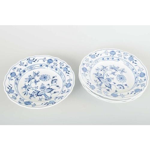 Meissen 4 soup plates, “Blue Onion” pattern, mid-20th century. Four hand-painted porcelain soup plates with underglaze...
