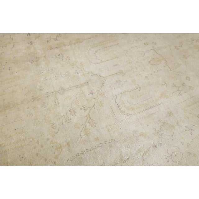 an early 20th century Pale Ivory field Turkish Oushak Rug that has been antique washed. some yellow and blue dominant...