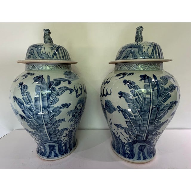 An impressive pair of monumental blue and white Chinese porcelain covered temple jars featuring hand-painted dragons...