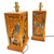 A striking pair of mid-century table lamps hand made in Honolulu, Hawaii featuring beautifully carved wood panels with...