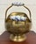 This is a vintage brass coal scuttle featuring ornate lion-head accents, porcelain delft roller handles, and a classic...