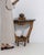 This piece presents as a table, distinguished by natural honey oak, carved openwork stretcher. The piece dates to Early...