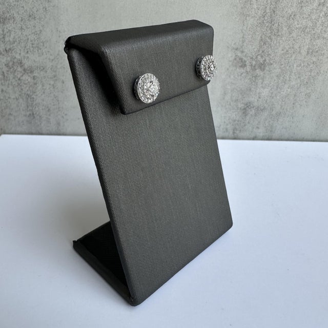 These exquisite 10kt White Gold Diamond Halo Stud Earrings are the perfect blend of elegance and sparkle. Featuring a...