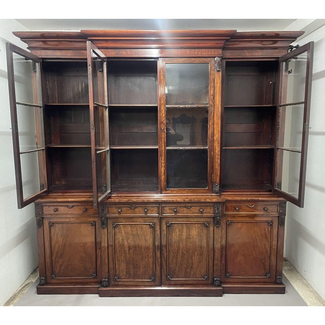 A superb quality early 19th Century mahogany breakfront bookcase, the stepped moulded cornice above four large glazed...
