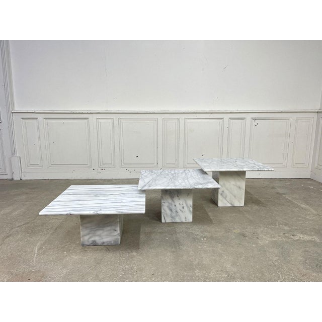 These three nesting tables are made of gray marble, possibly Carrara. Their simple lines and the beauty of the marble's...