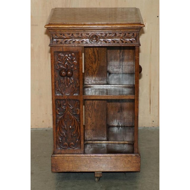 Very well made, fully restored English oak circa 1880 revolving bookcase table with lovely carved panels A good looking...