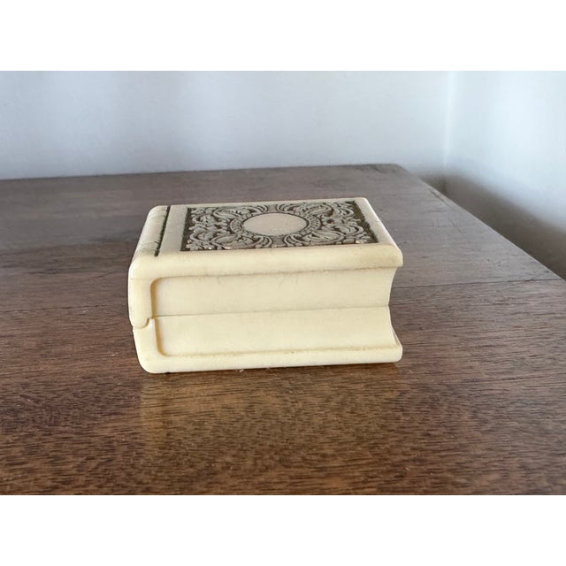 Created in the shape of a book, this antique jeweler's box would make an amazing presentation for a special ring or a...