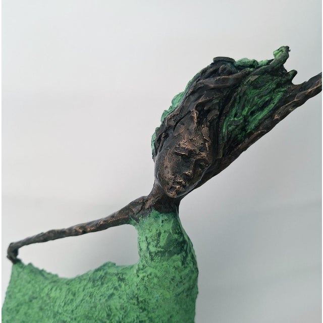 This captivating sculpture presents a figure in graceful motion, exuding an ethereal sense of freedom and elegance. The...