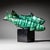 Ceramic sculpture depicting two trout with a green-black enameled surface. The group is mounted on a black cubic base....