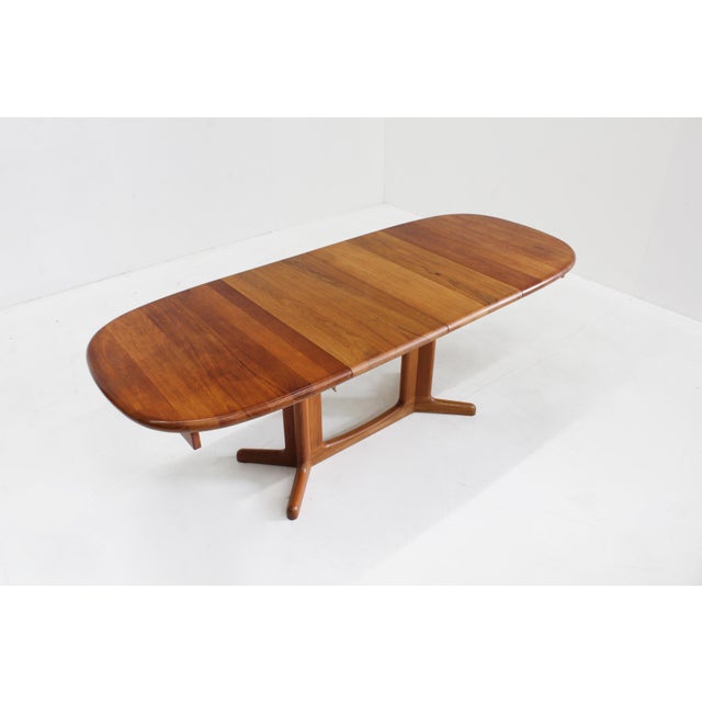 Vintage Danish oval extendable dining table from the 1960s made of solid teak. Extendable with two extension leaves to 199...