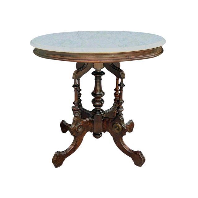 A charming antique Renaissance Revival side table featuring an elegant bobbin-turned walnut base and a beautifully veined...