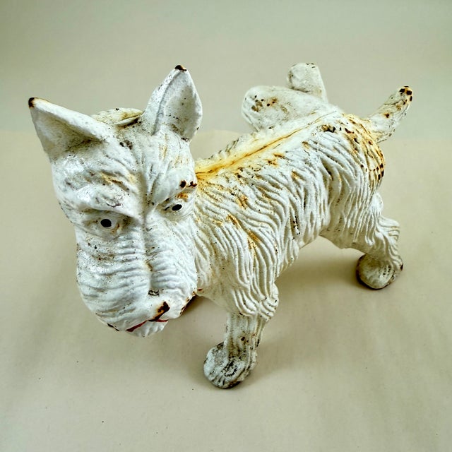 A Scottish Terrier cast iron doorstop or bookend, commonly known as The Naughty Scottie due to his lifted hind leg – in...