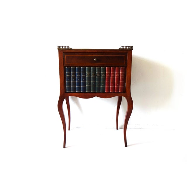 A pair of vintage French end tables. Marquetry inlay on front, sides, and back in kingwood and a blond wood. Cabriole...